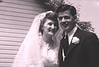 Black and white photo showing a bride and groom from the chest up on their wedding day.