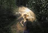 Woman with umbrella in rain with sun and clouds inside showing her sunny disposition.