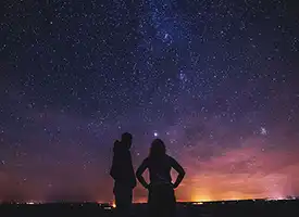 A couple gazes into the heavens