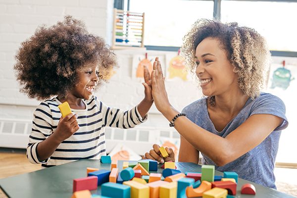 Mother and Daughter High-Fiving each other